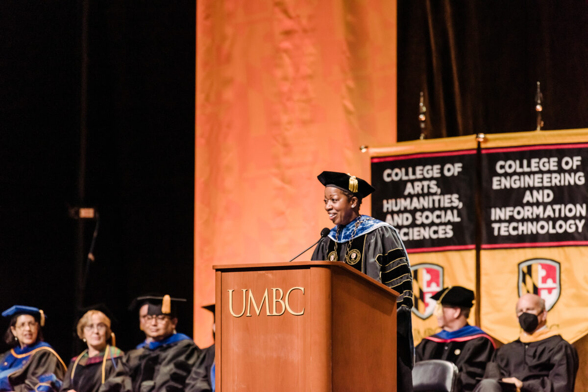 UMBC president Valerie Sheares Ashby stands at UMBC podium in official regalia