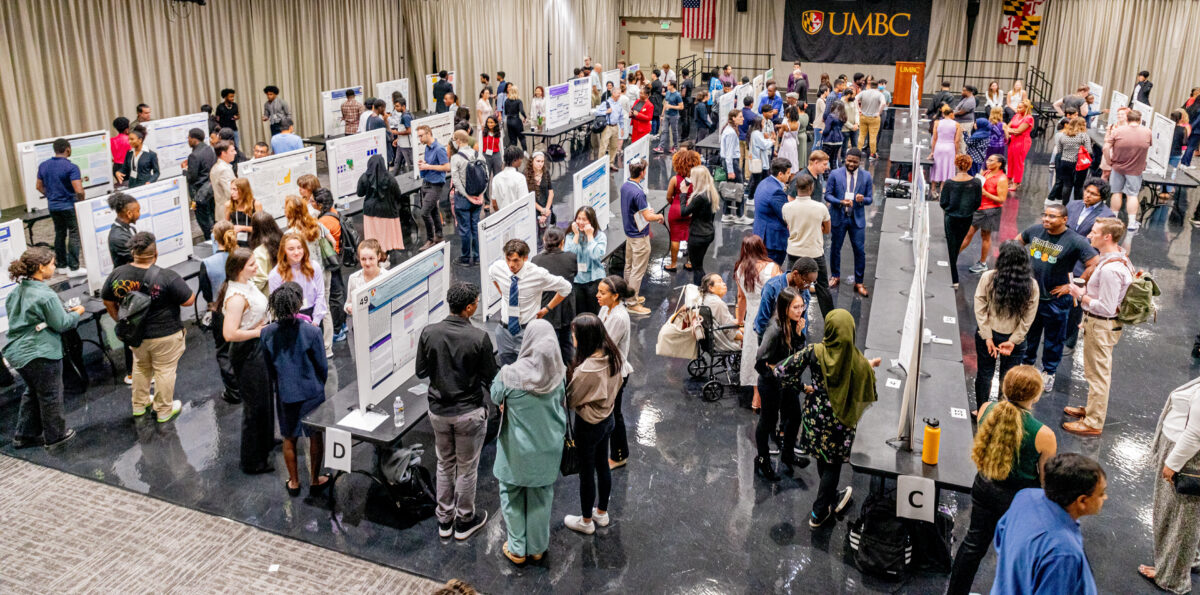 a large ballroom full of people and rows of research posters