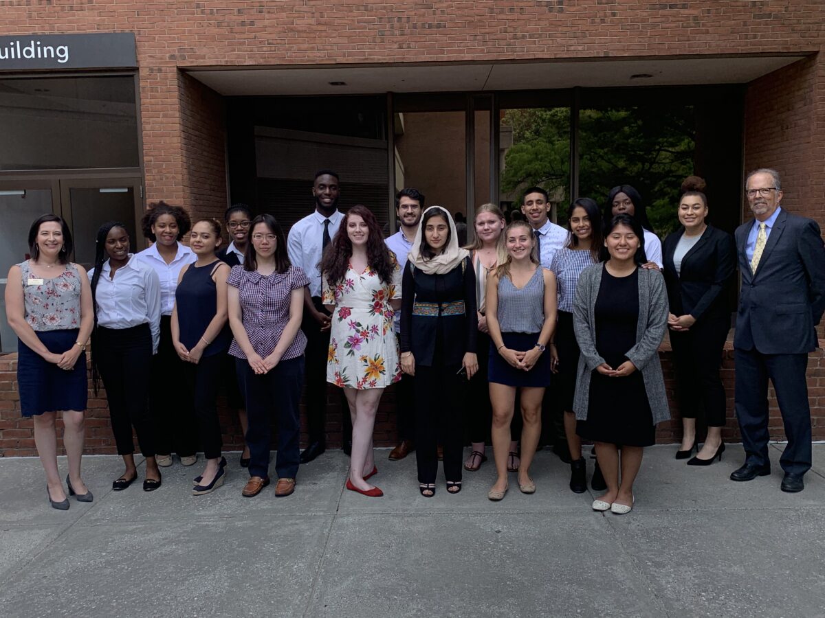 group photo of students and faculty dressed professionally