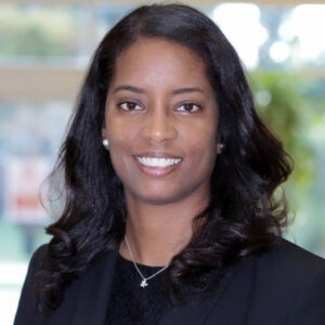 Portrait of Candace Dodson-Reed outside, wearing a black suit.
