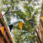 black and gold flags span across academic row