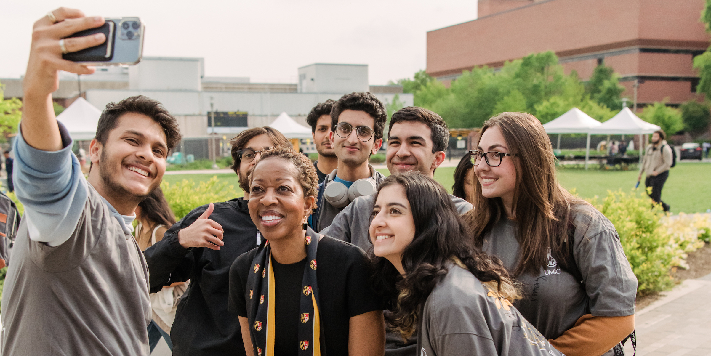 Students pose for a selfie with President Sheares Ashby at the post-inauguration celebration on the Quad.