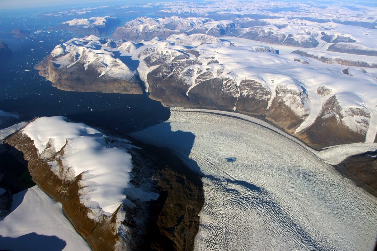 Aerial view of rugged landscape with snow and ice.