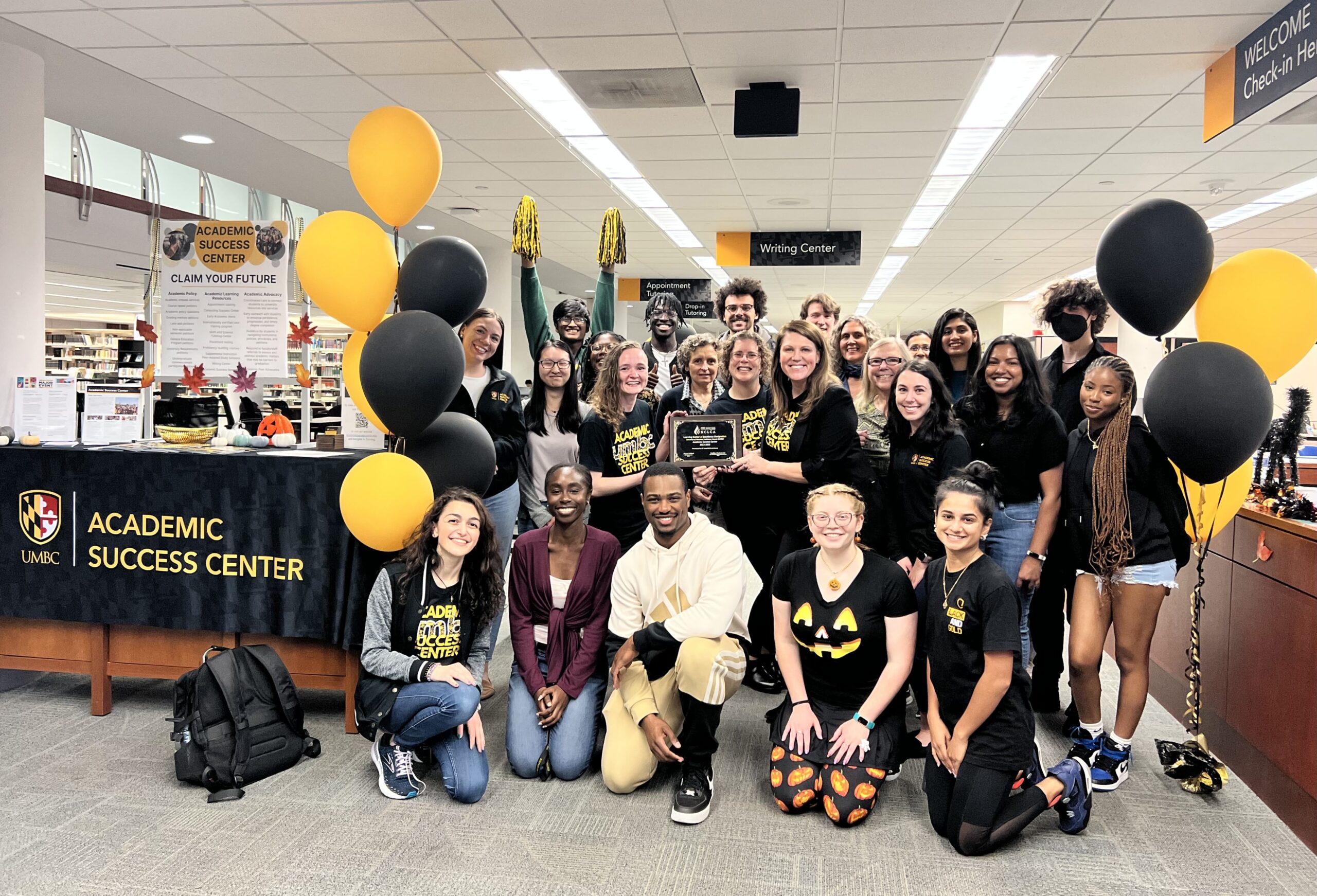 students dressed in black and gold celebrate at the academic success center