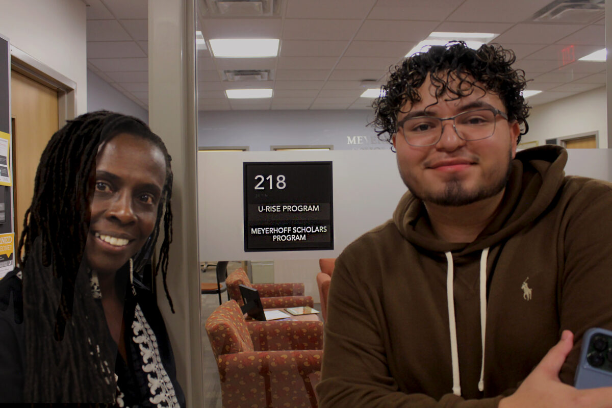 Noah Cruz a pre-med student (right) with Dr. Jacqueline King, Associate Director of the U-RISE Program (left), in front of the Meyerhoff and U-RISE Scholars Program Office.