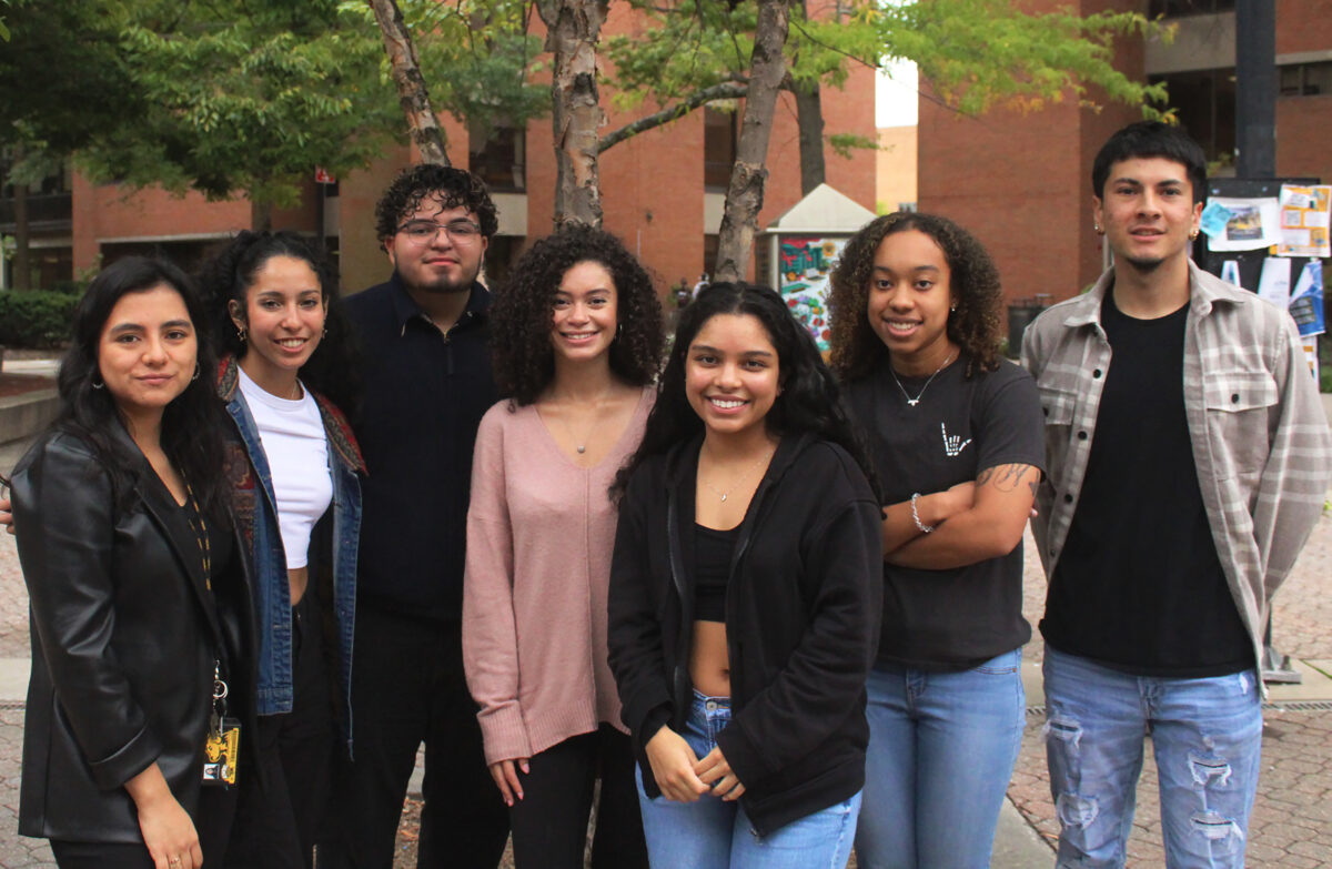  A group of students pose together outside beneath trees