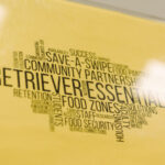 Printed text on yellow background as a word cloud, including words "Retriever Essentials. Community partnerships. Save-a-swipe"