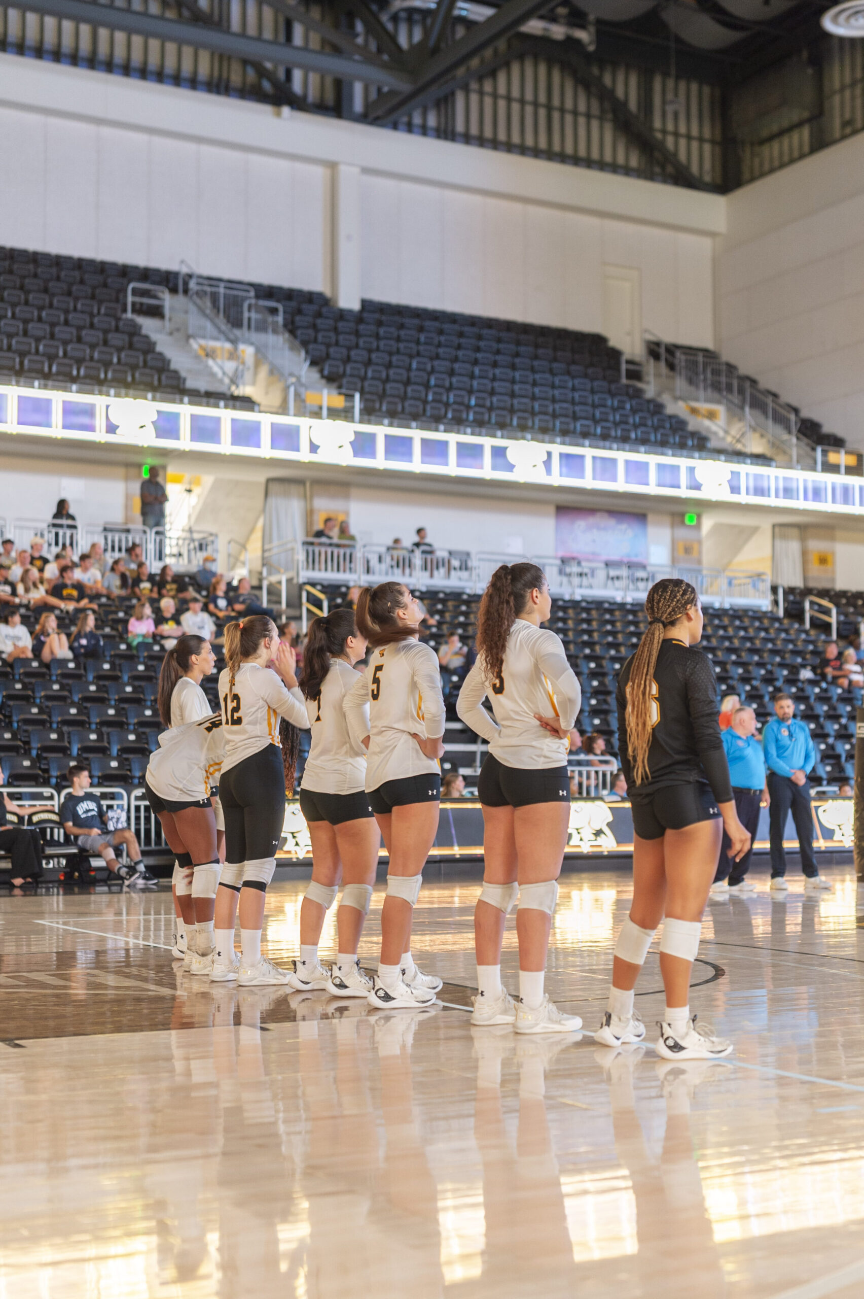 volleyball players stand together on the court