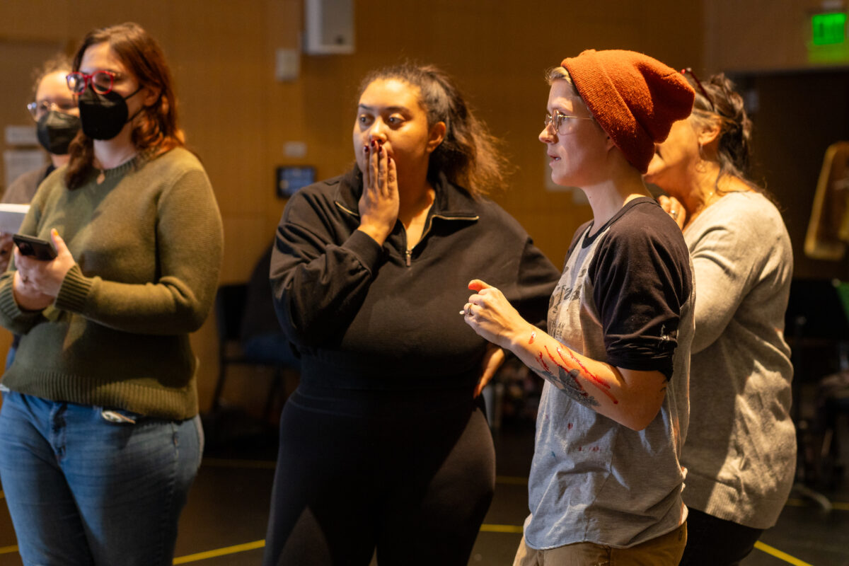 two directors discuss rehearsal