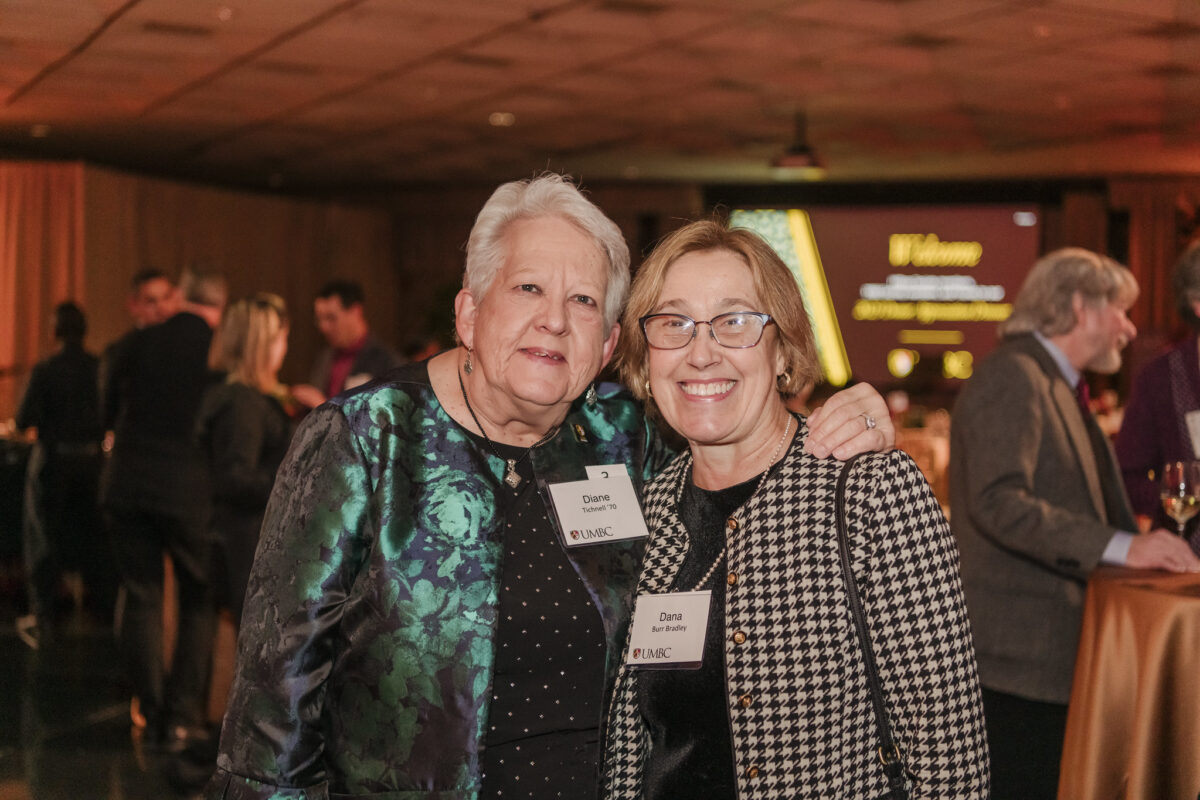 Diane Tichnell and Erickson School Dean Dana Burr Bradley embrace.