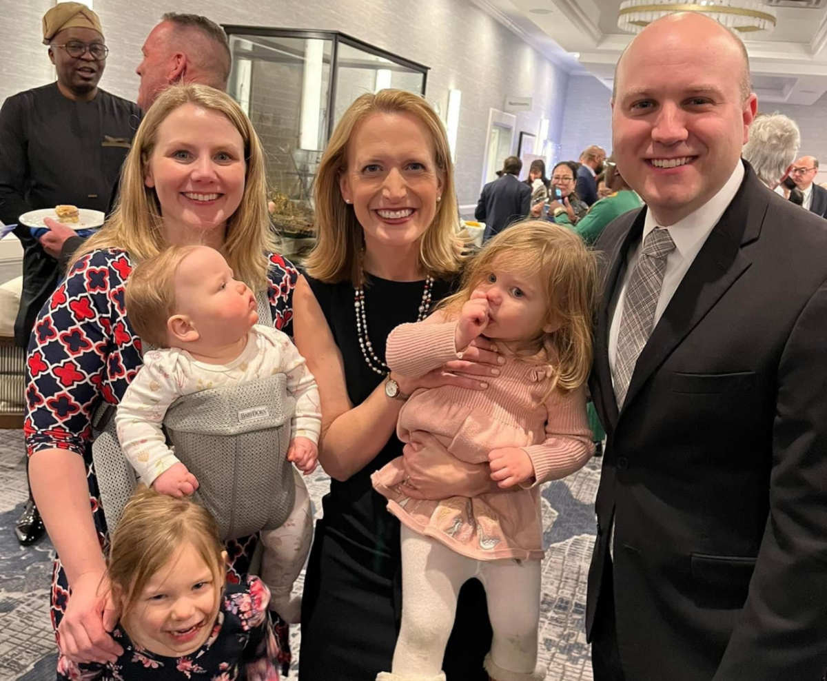Brian and Angela Frazee and their three daughters posing with Maryland Comptroller Brooke Lierman at her inaugural celebration