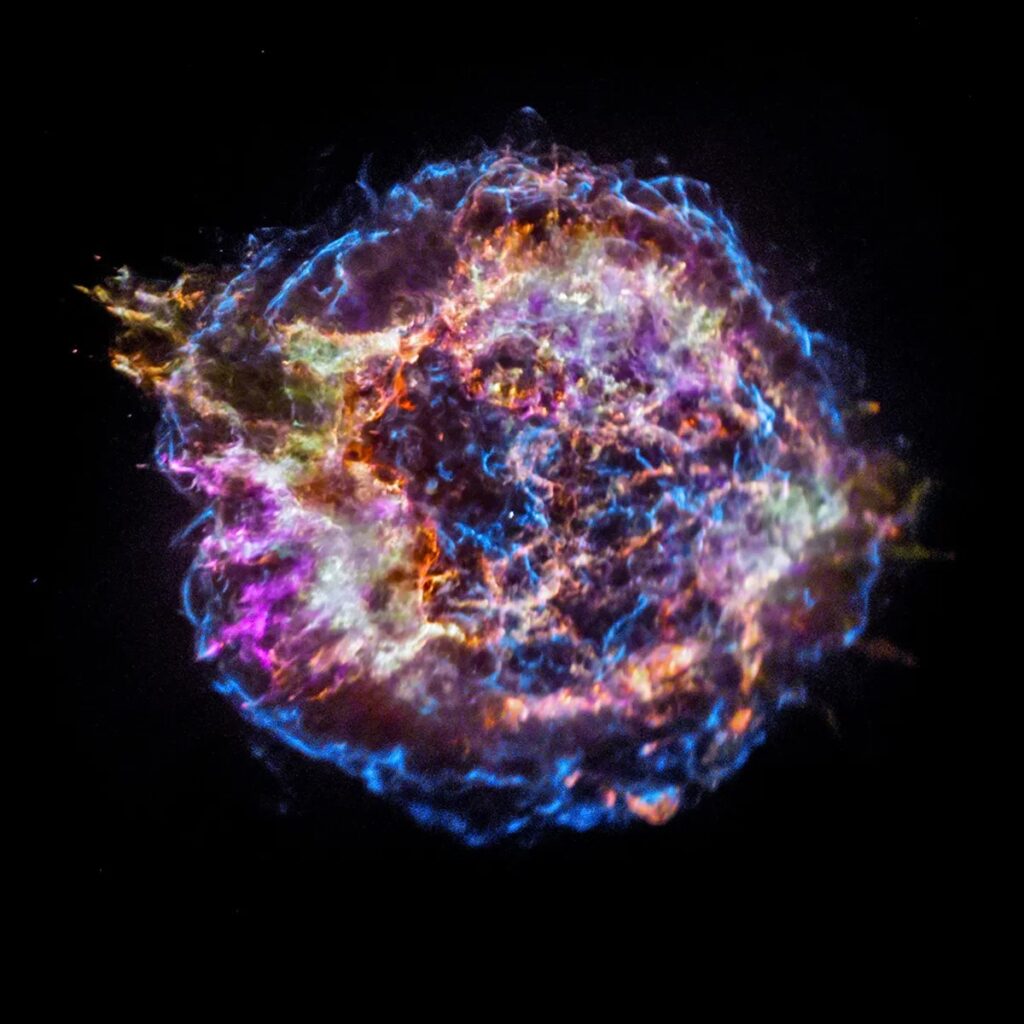 a massive explosion on a black background, colored primarily purple and blue 