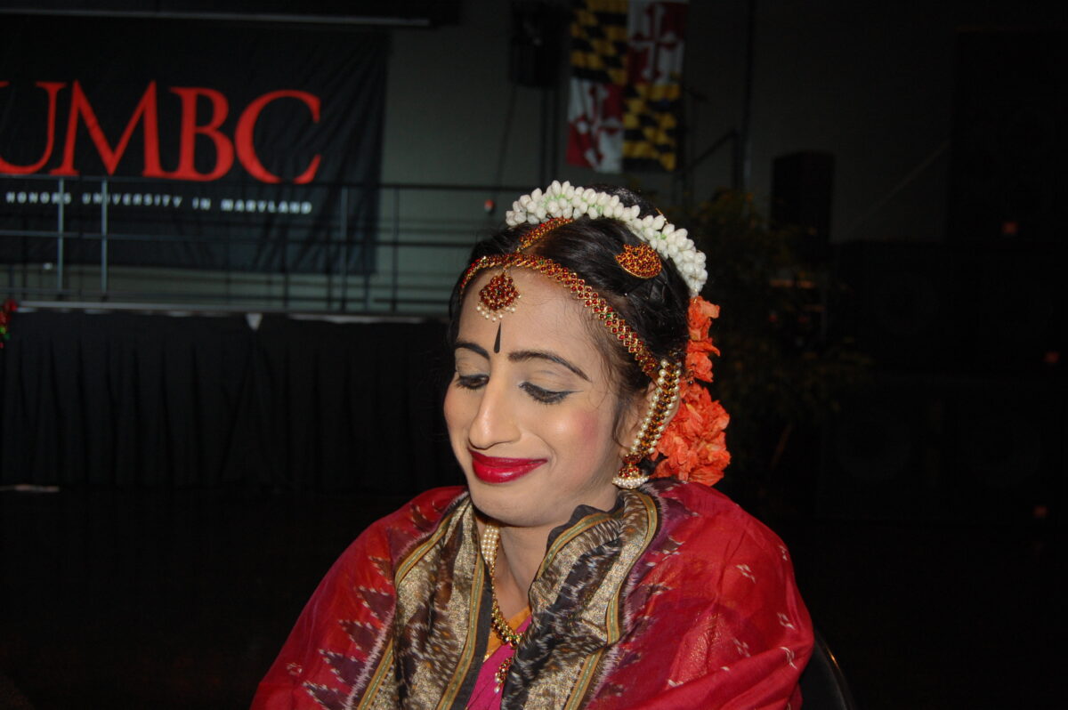 an indian woman in decorate make up and outfit poses