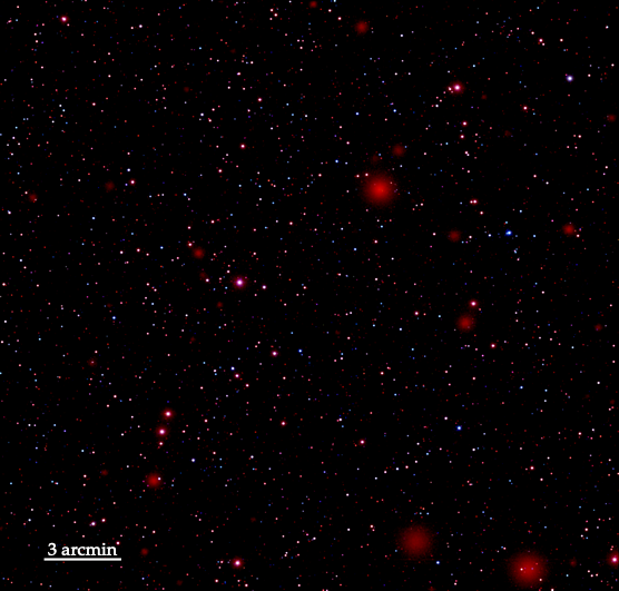 X-ray view of space. Red and pink dots on a black background; scale bar at bottom left marks about 1/8 of the image length as 3 arc minutes.