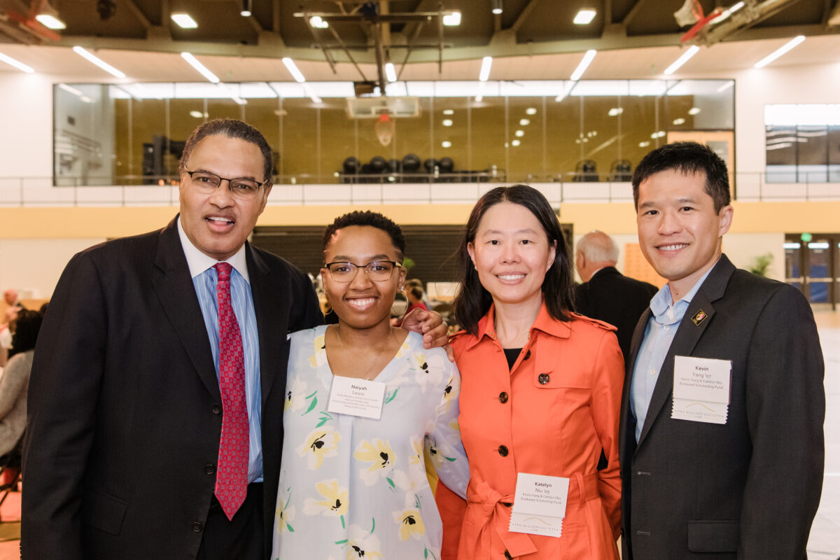 Katelyn Niu and Kevin Yang pose for a photo with Naiyah Lewis, one of their scholars, and UMBC President Emeritus Dr. Freeman A. Hrabowski, III at the 2022 Endowed Scholars Luncheon.