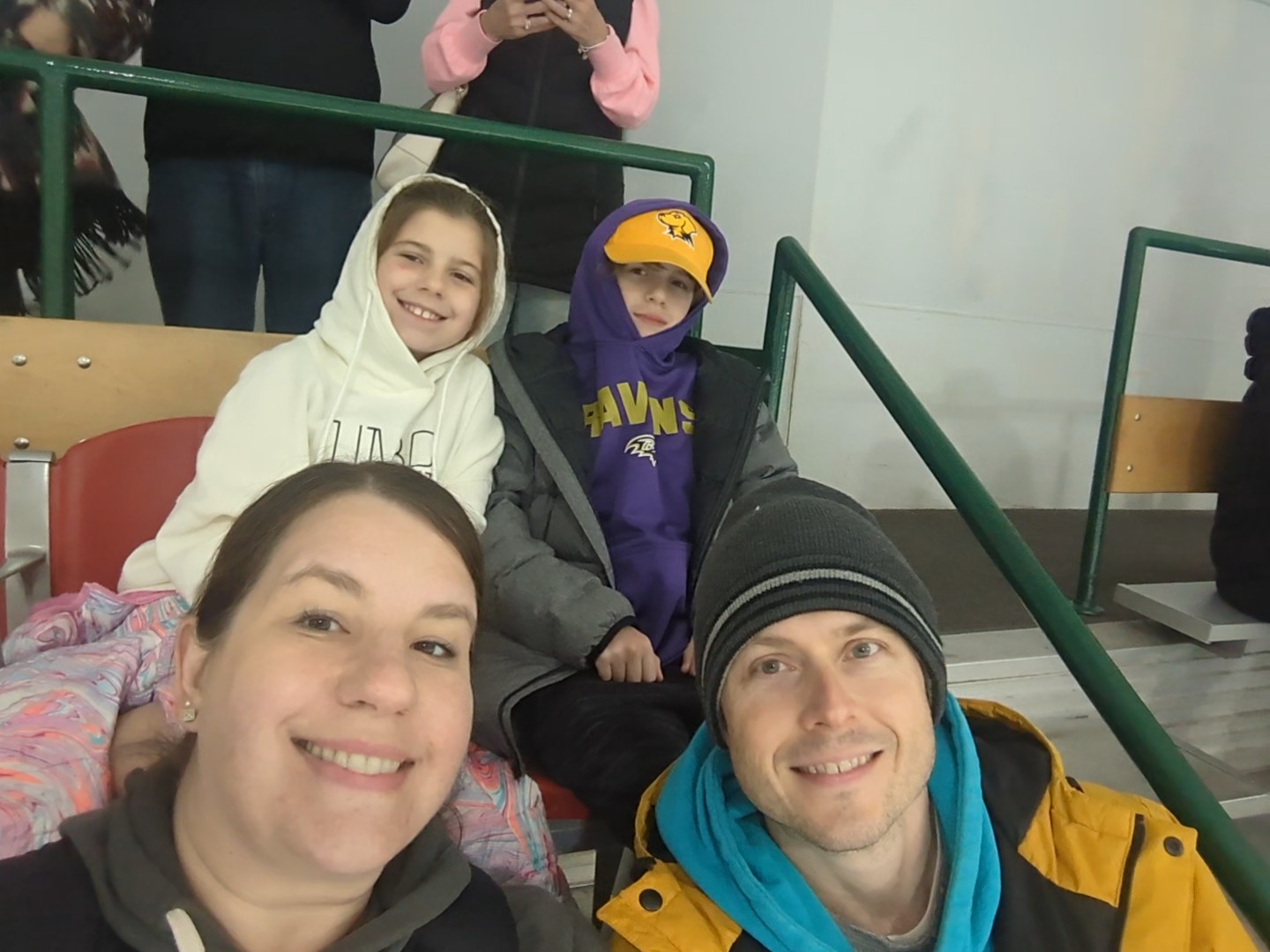 Lisa Nissley and her family at a UMBC ice hockey game during homecoming in 2023.