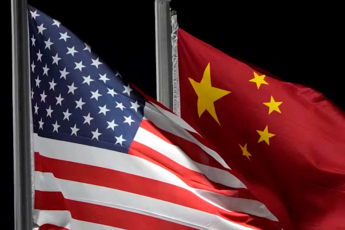American and Chinese flags fly side by side.