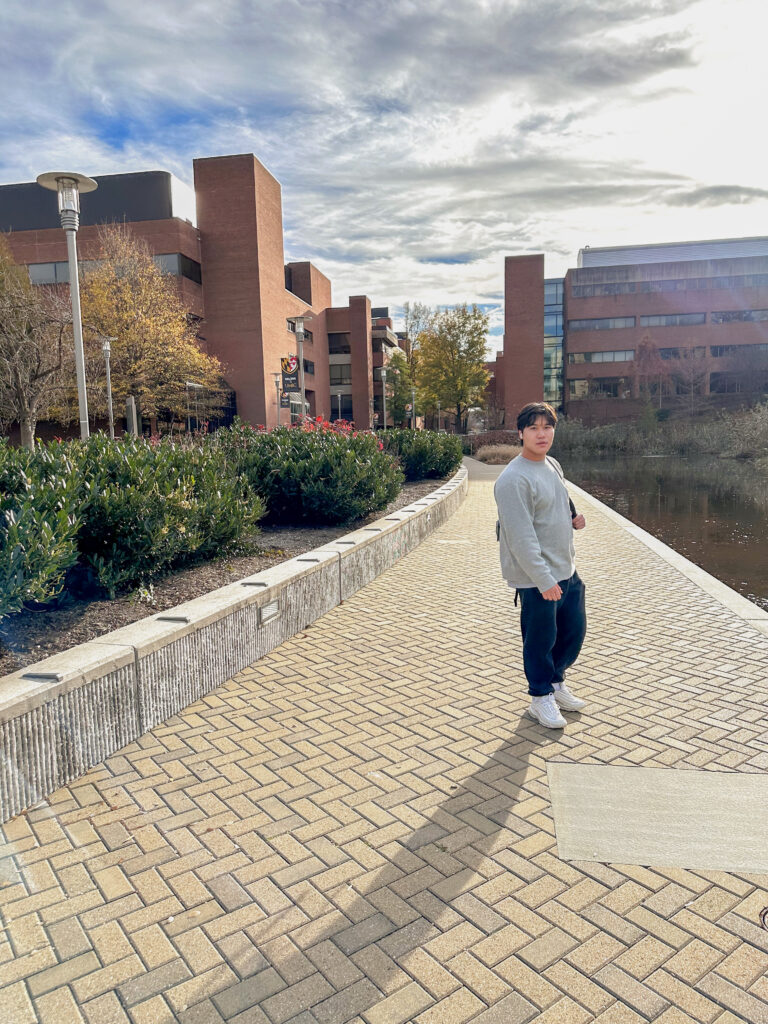 Garvey poses near Library Pond on UMBC's main campus. Photo courtesy of Chu.