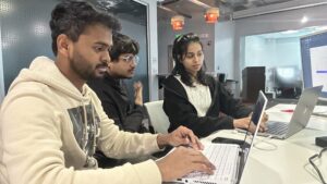 Student tech interns work on a project together