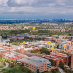UMBC's campus from a bird's eye view, with gold location pegs superimposed the image to indicate research zones
