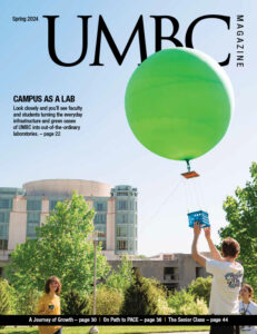 UMBC's Spring 2024 magazine cover, featuring a large green balloon being released into the sky by students for a lab research project.