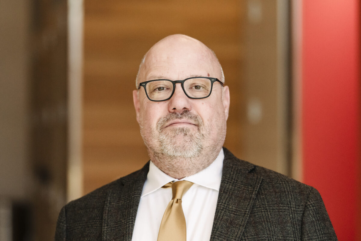 headshot of UMBC's new provost, Manfred van Dulmen--a man with glasses in a suit and tie