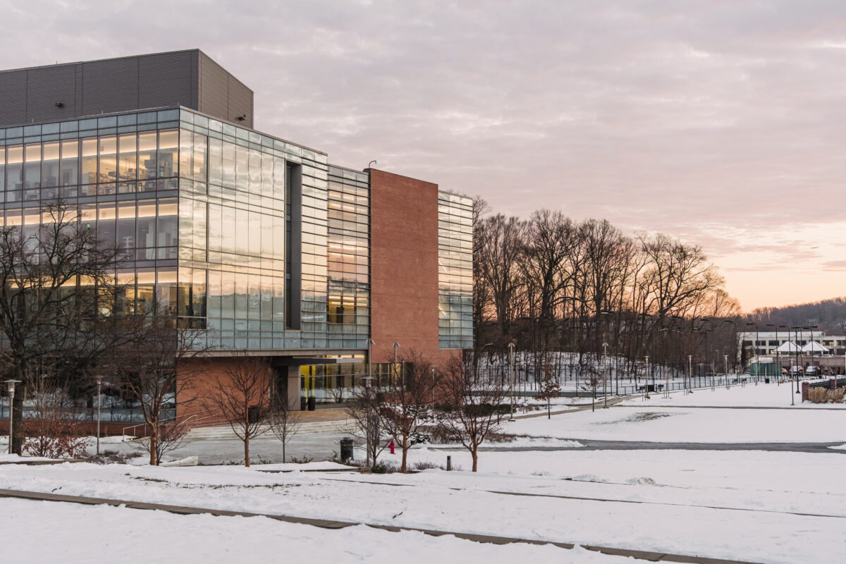 The Interdisciplinary Science Building on UMBC's campus, surrounded by snow on the ground as the sun goes down