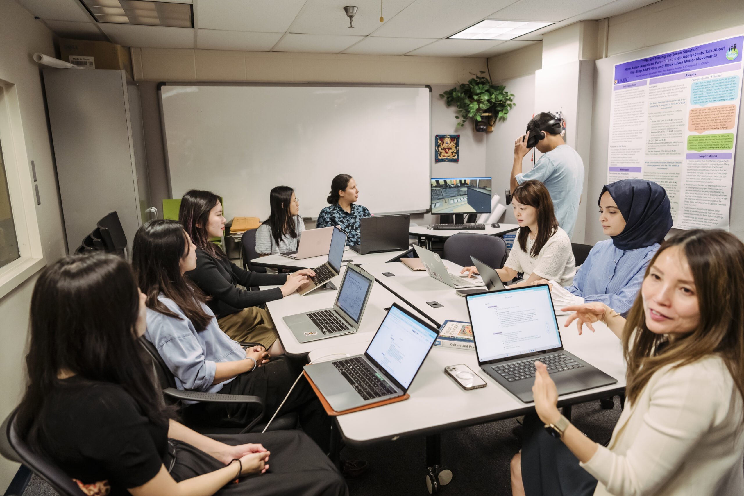 Charissa Chea sits with the students who work in her lab