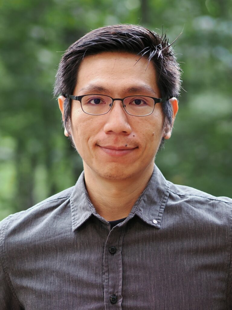 portrait of man, blurred greenery in background