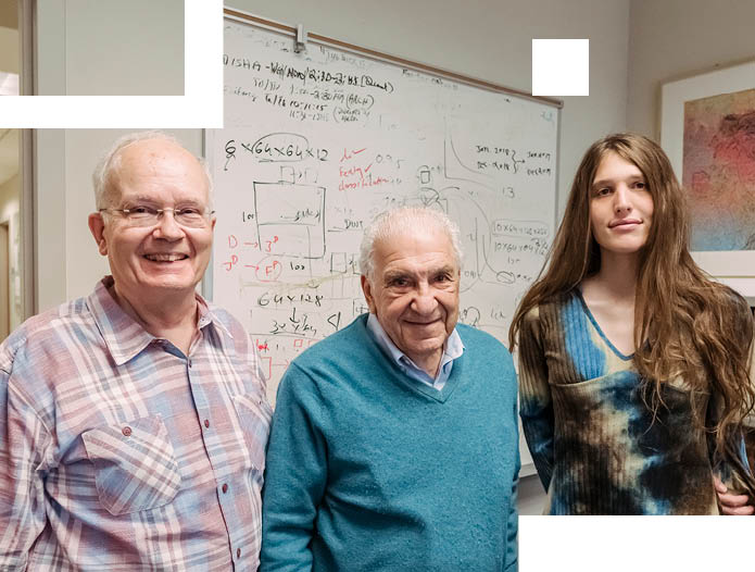 Jim Fischer, Milt Halem, and Sophia Hamer (left to right) in Halem’s UMBC office. One of Halem’s screen prints hangs in the upper right.