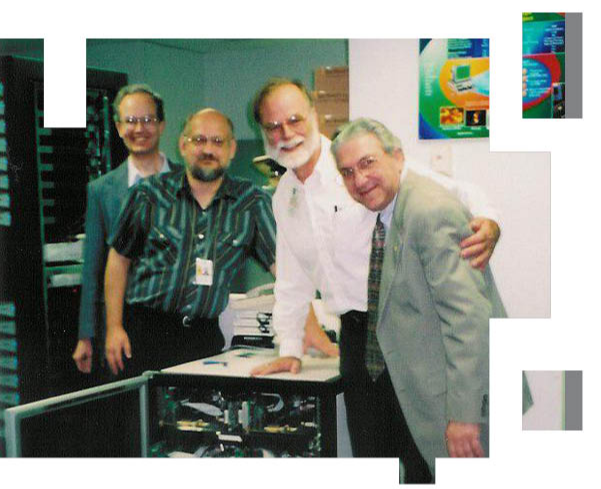 Halem (far right) poses with (from left to right) NASA's Jim Fischer and John Dorband, and Microsoft Fellow Jim Gray next to the first Beowulf computing cluster. Photo by NASA.