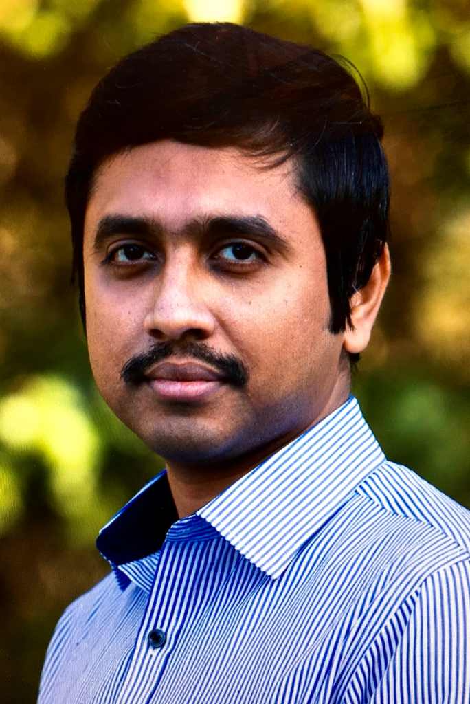 portrait of man; blurred outdoor background