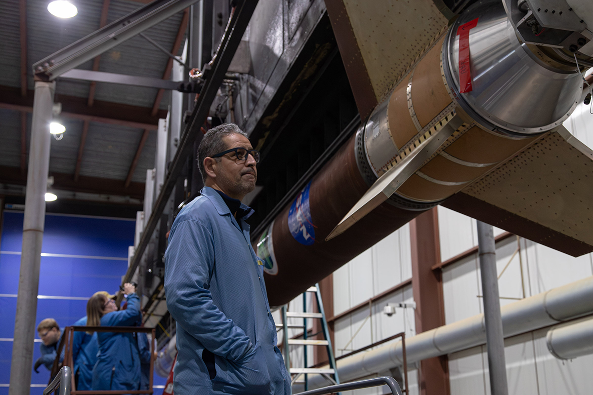 Dr. Mehdi Benna, a CSST Senior Research Scientist, with the Dissipation sounding rocket used in his research. Photo Credit: by Danielle Johnson/NASA Wallops Flight Facility.
