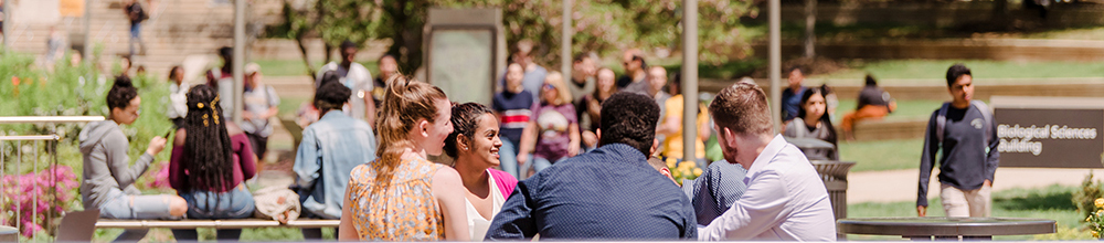 students sitting outside at a table together