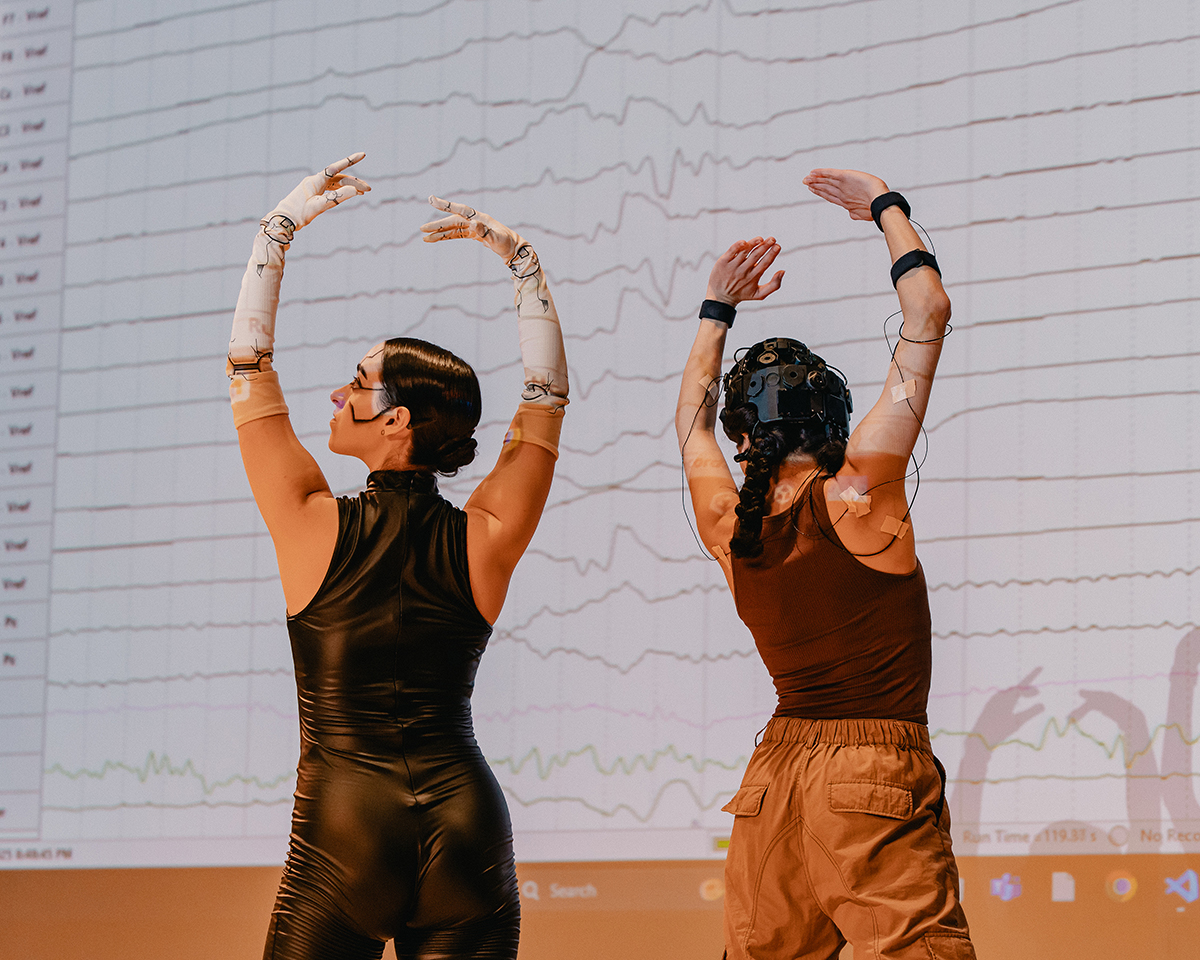Dancers Sarah McHale '24 and Juju Ayoub '25 perform during the AccelNet meeting. The dance was a demonstration of a collaborative research project by UMBC faculty Ramana Vinjamuri, Andrea Kleinsmith, and Ann Sofie Clemmensen exploring stress reducing technology.