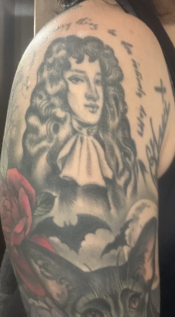 A black and white tattoo of a of John Wilmot, the Second Earl of Rochester, a late 17th-century English nobleman wrote erotic works
