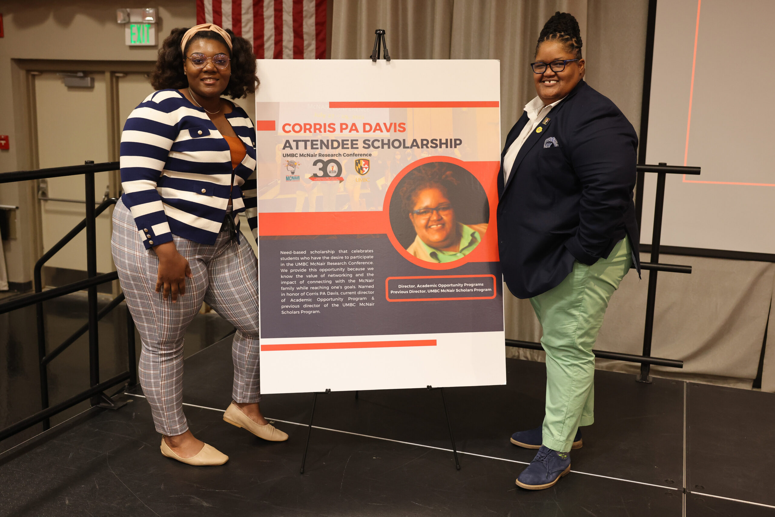 two people stand in front of a sign that says Corris Davis PA Attendee Scholarship