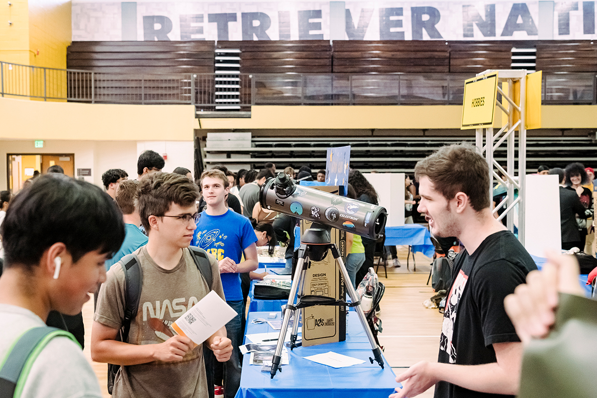 umbc's involvement fest featuring students talking and a telescope