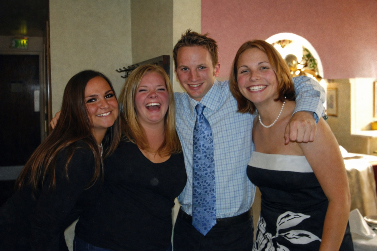 group of four college students dressed up for going out