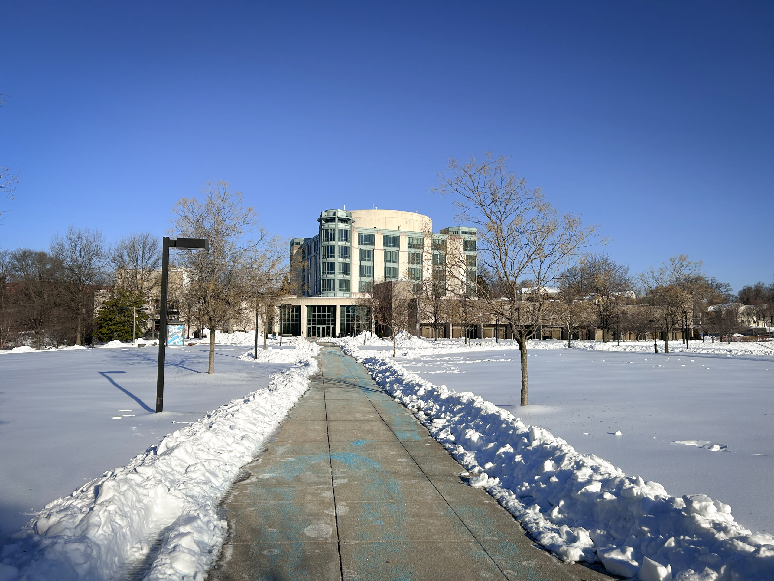 snow lines the walkway leading to UMBC's Albin O. Kuhn Library