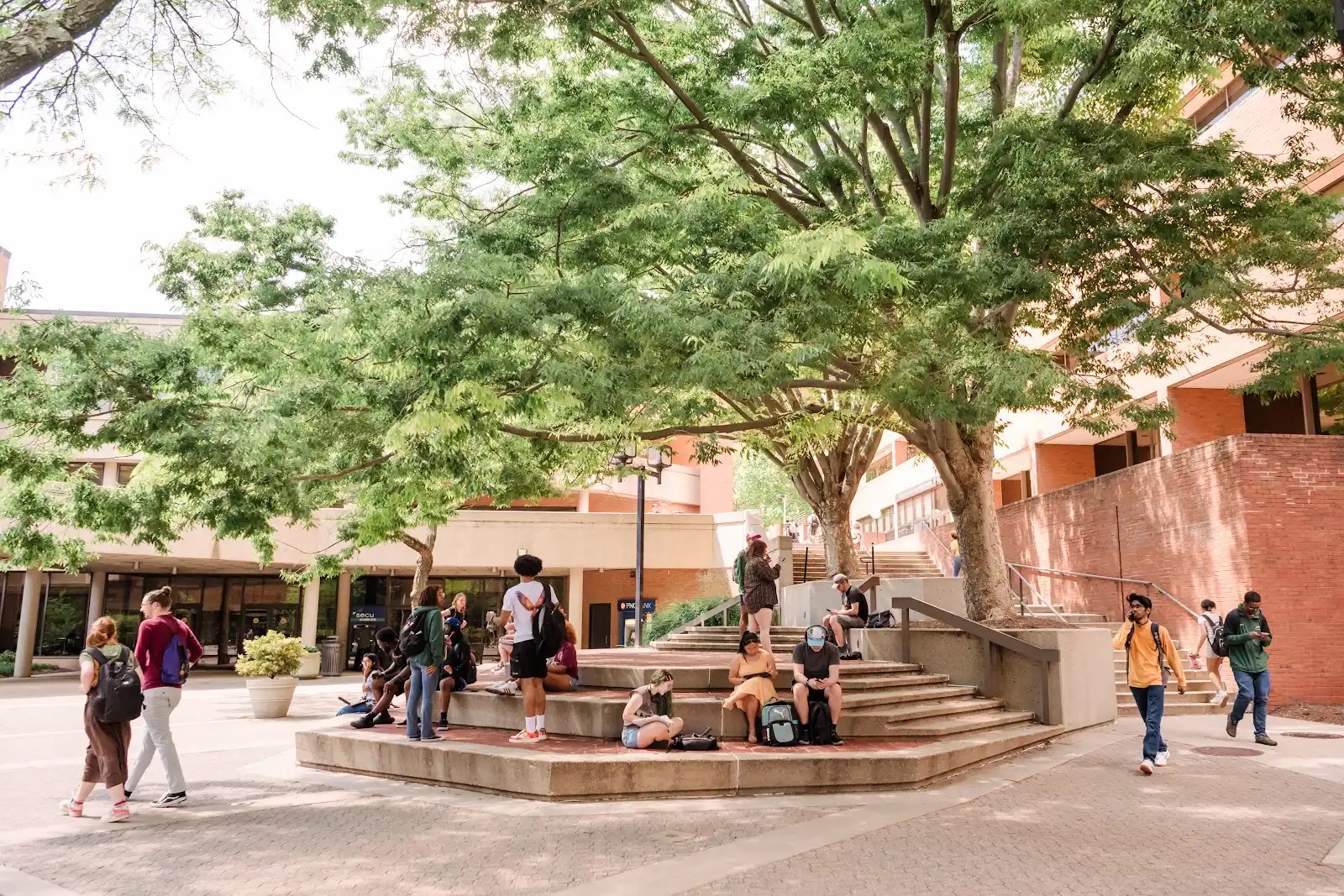 Students meet and sit on a layered seating area in front of UMBC's University Center