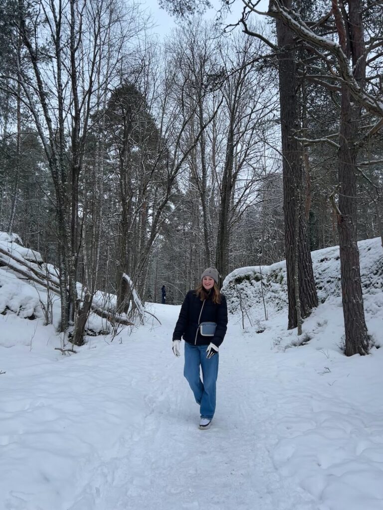 Kayla Nemirovsky from UMBC in a snowy wooded forest in Finland 