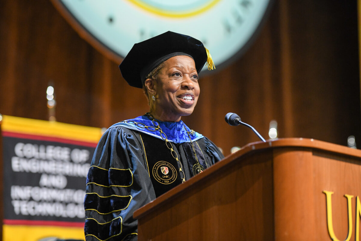 President Valerie Sheares Ashby speaks from a podium in regalia