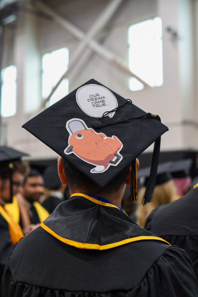Mortarboard reads "Our dream came true" with cartoon pokemon