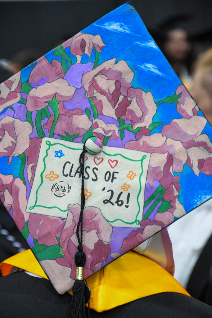 Floral mortarboard reads "Class of '26"