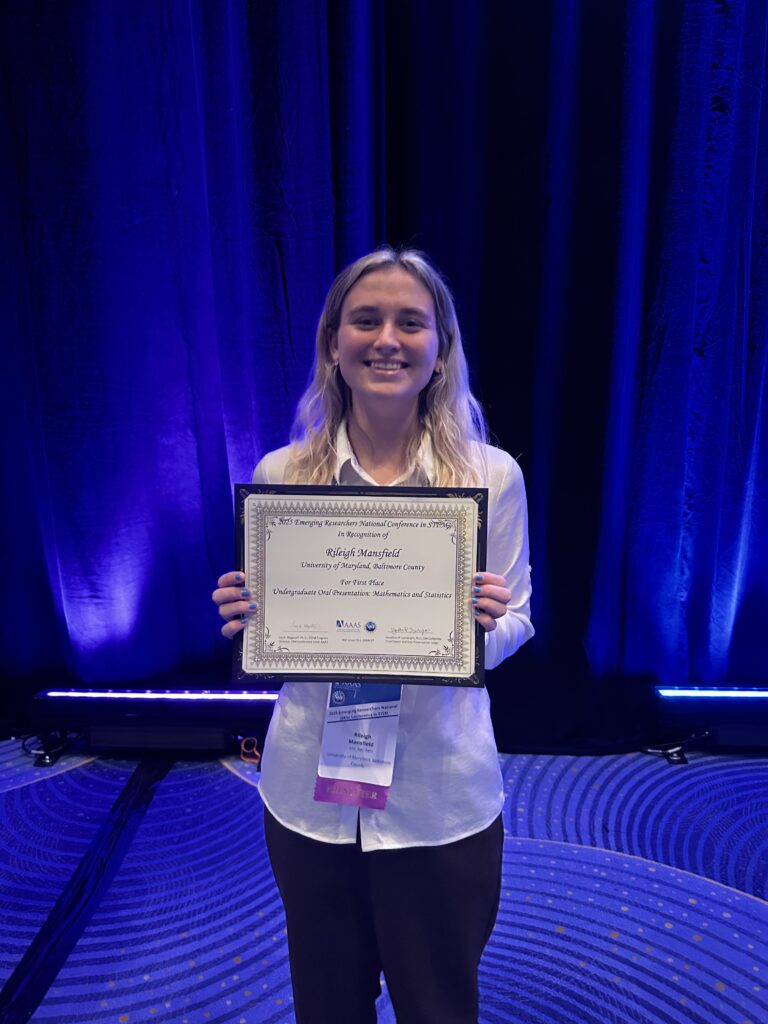 Rileigh Mansifled holding a framed certificate