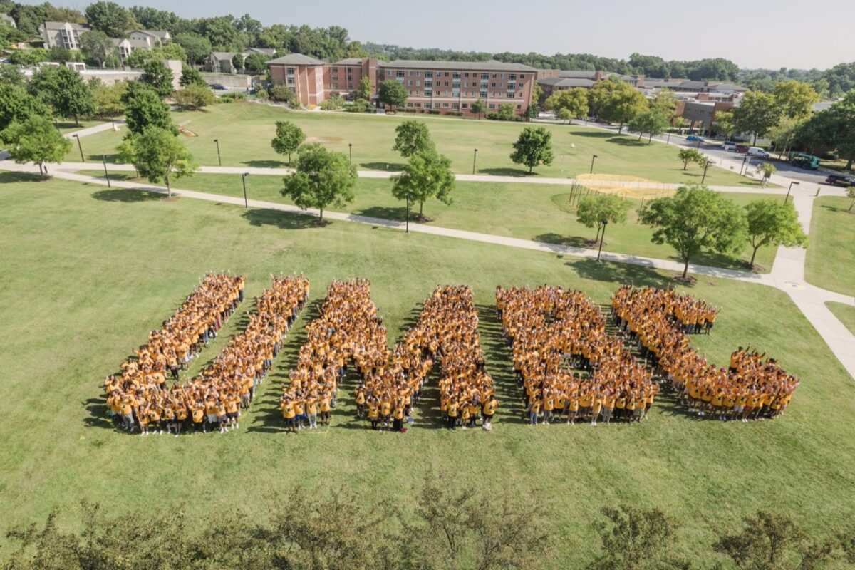 Students form the letters UMBC on a field.
