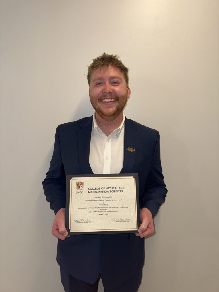 Payton Barry holding his framed Outstanding TA certificate