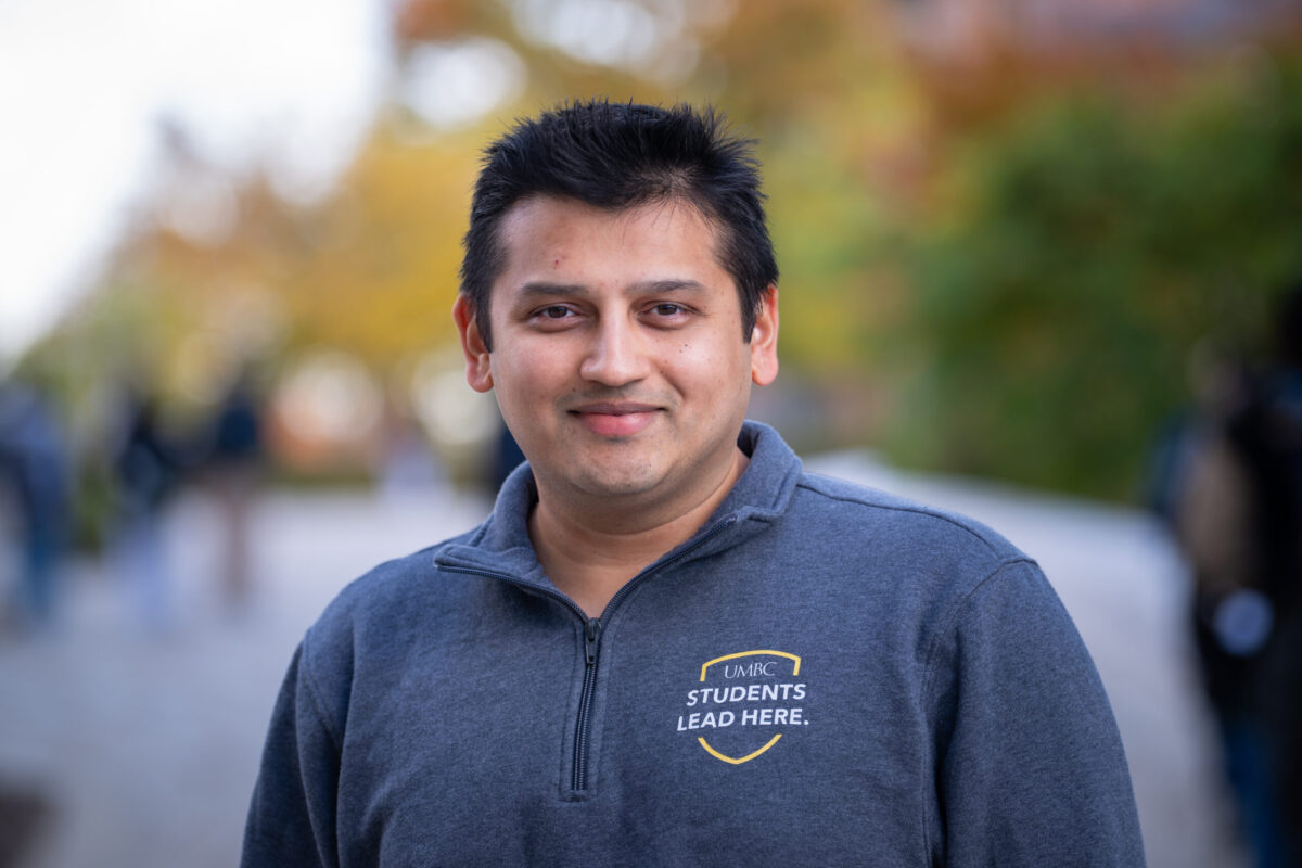 headhot of Yash Bhatt in a zip up that says UMBC: Students lead here