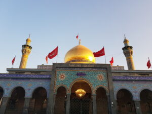 Sayyida Zainab shrine, near Damascus, Syria with a gold dome and glazed tiles creating colorful geometric shapes that cover the entire building